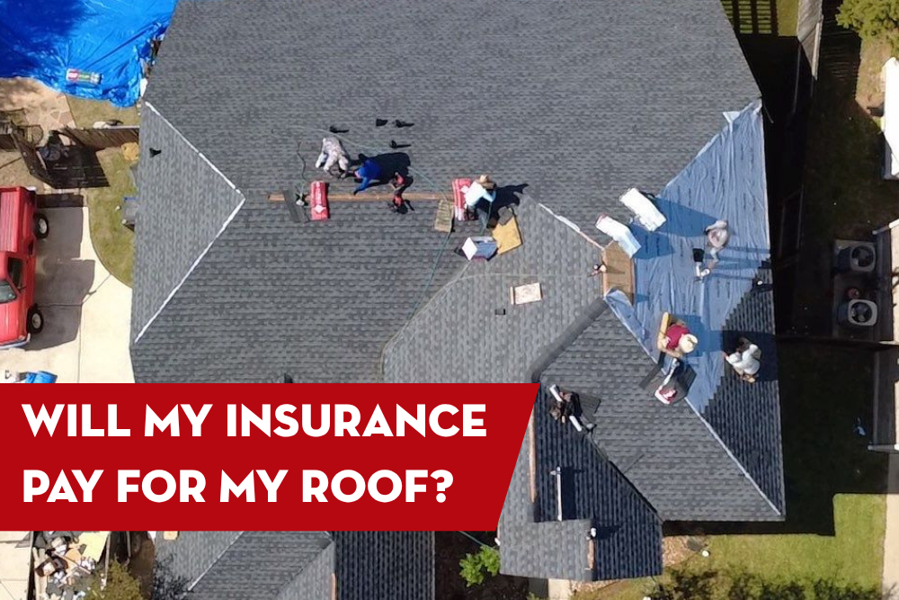 Aerial view of a residential roof with a roofing crew installing shingles, with a red banner overlay that reads “Will My Insurance Pay for My Roof?”