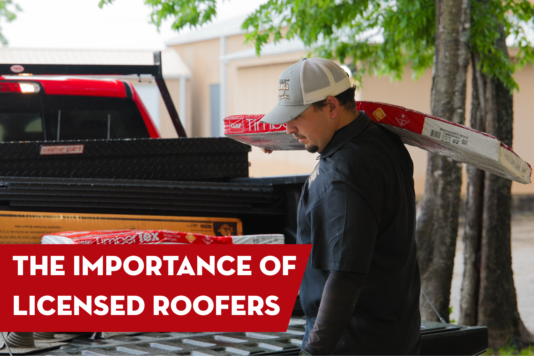 Professional roofing contractor carrying roofing materials beside a work truck highlighting the importance of hiring licensed roofers