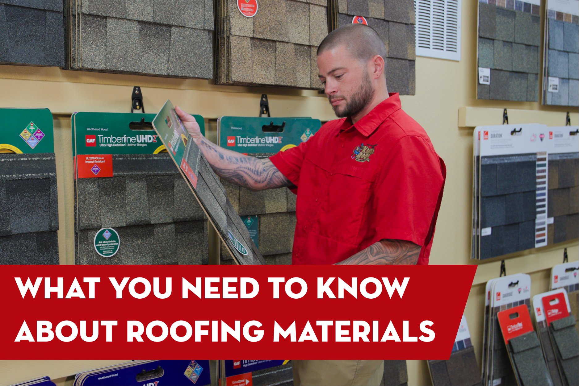Roofing contractor reviewing asphalt shingle samples in a showroom, explaining important roofing material options and features for homeowners