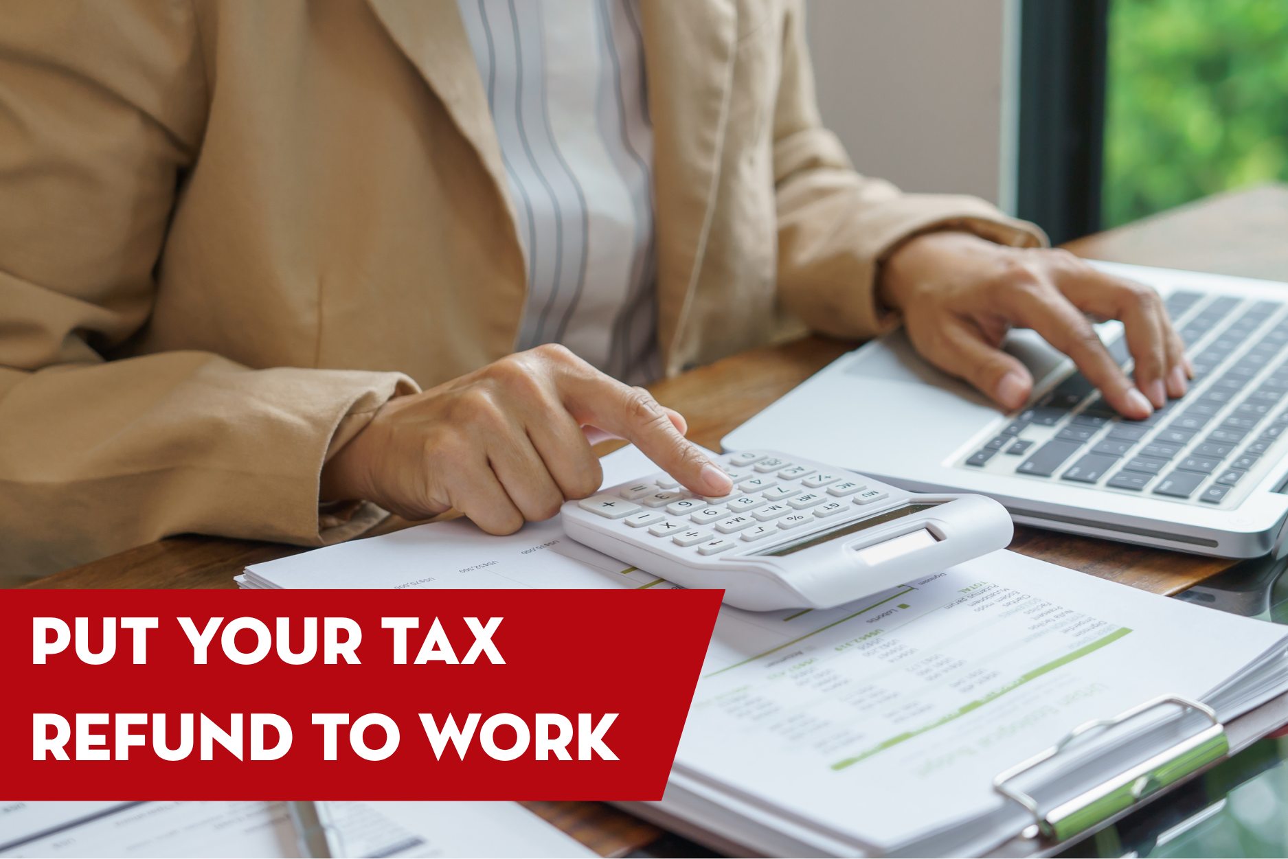 Homeowner using a calculator and laptop to budget a tax refund for home improvement projects like roof repair or roof replacement